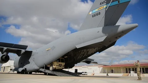 Vehicles being unloaded from C-17 in support of Operation Faithful Patriot-2018 Stock Footage 106150082