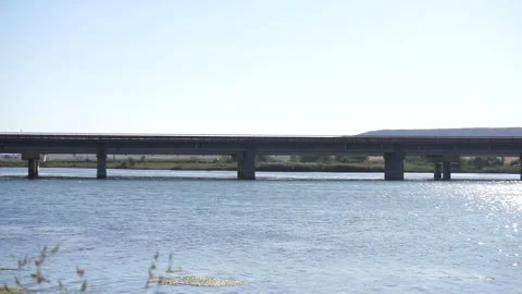 Vehicles crossing the bridge over the river. Video stock 257598761