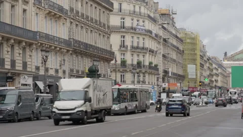 Vehicles drive down an avenue past historic buildings towards an opera house Stock Footage 336722320