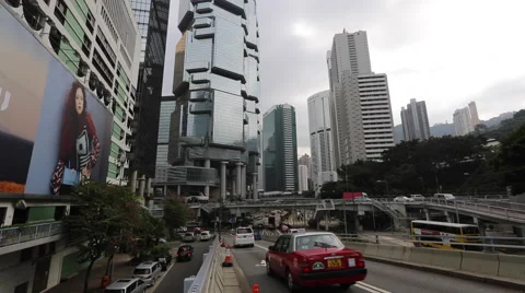 Vehicles drive on a flyover through office buildings in Hong Kong Central Stock Footage 45133453