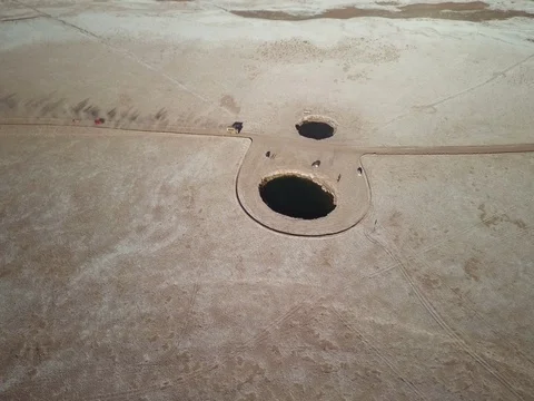 Vehicles drive through Ojos de Salar in northern Chile Stock Footage 83296470