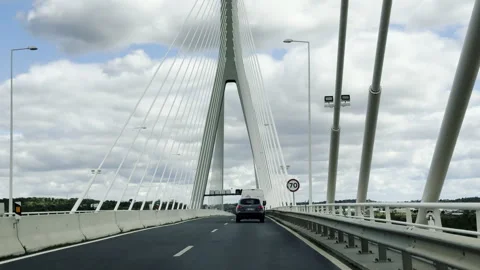 Vehicles drive toward the modern cable stayed bridge crossing the Guadiana River 库存影片 330745308