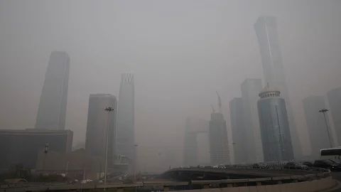 Vehicles driving amid heavy smog on a polluted day in Beijing's CBD Stock Footage