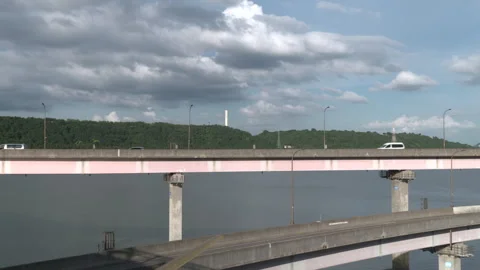 Vehicles driving on an elevated roadway over a river Vídeo Stock 336757704