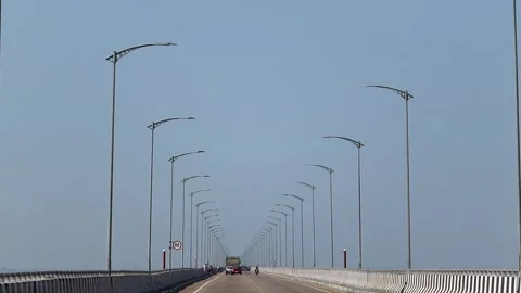 Vehicles driving on a long bridge with rows of street lights Stock Footage 330708944