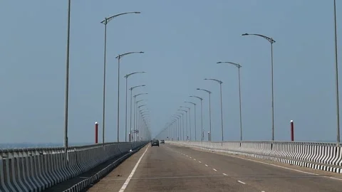 Vehicles driving on a long river bridge with street lights Stock Footage 330708864