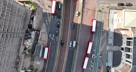 Vehicles driving on multilane road along group of standing buses Video stock 201897013