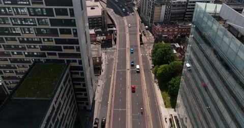 Vehicles driving on multilane trunk road between tall buildings Video stock 201894923