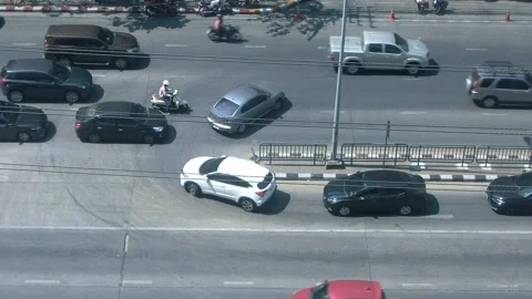 Vehicles driving on road during rush hour sunny day top view. Urban Bangkok Stock Footage 231717048