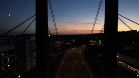 Vehicles driving on road leading on cable stayed bridge over river Video stock 166586239