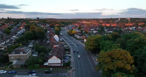 Vehicles driving on road leading through urban neighbourhood Vídeos de archivo 201883307