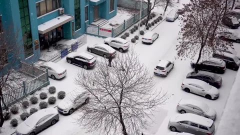 Vehicles Driving Slowly Through Snow Covered Road on a Winter Day Video stock 341913484