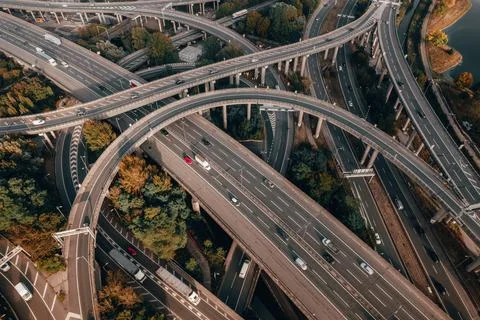 Vehicles Driving on a Spaghetti Interchange at Sunset Stock Photos
