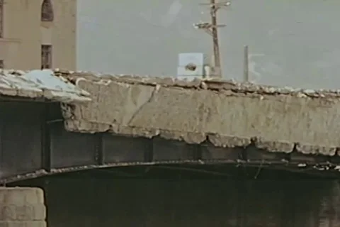 Vehicles driving through destructive bridge - 1946 Stock Footage 103372445