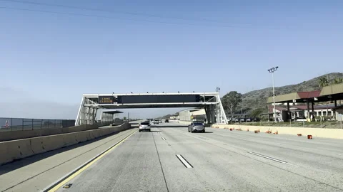 Vehicles driving through a Highway Border Patrol Checkpoint 4k ProRes Video Stock Footage 304298069