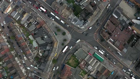 Vehicles driving through road intersection in urban neighbourhood Stock-Footage 161290079