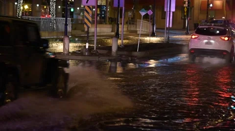 Vehicles Driving Through Water at Watermain Break Stock Footage 60737751