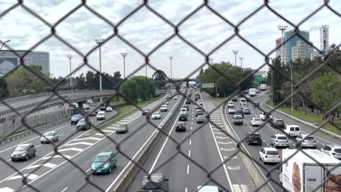 Vehicles driving on tracks, road junction, a shot through a fence net Stock Footage 246514469