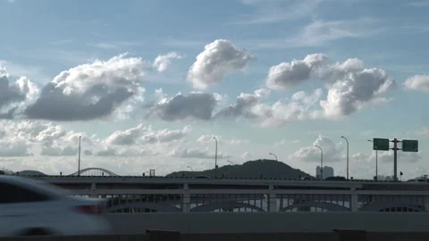 Vehicles driving under a clear sky with clouds Vídeo Stock 336757610