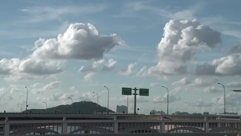 Vehicles driving under a clear sky with clouds Vídeos de archivo 336757792