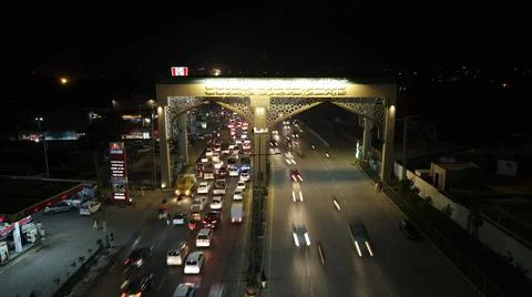 Vehicles exiting Bab-e-Lahore (Door of Lahore City) from the left side Stock Photos