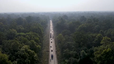 Vehicles in the forest Highway in Butwal Nepal aerial drone video Stock Footage