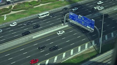 Vehicles glide along the bustling Sheikh Zayed Road in Dubai, UAE. Stock Footage 295101245