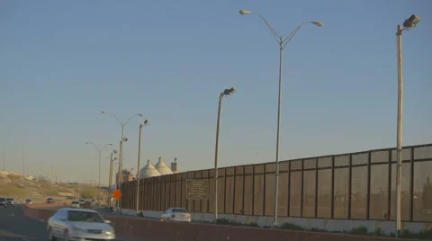 Vehicles on Highway by Border Fence Stock Footage 60119223