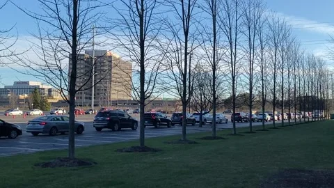 Vehicles lined up at COVID drive-thru testing site Stock Footage 143328863
