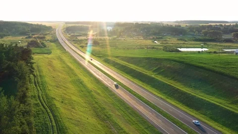 Vehicles Machines Driving Fast On High Speed Highway Against Sunset Aerial View Stock Footage 264908668