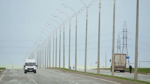 Vehicles Move along Highway with Lanterns against Grey Sky Stock Footage 73928033