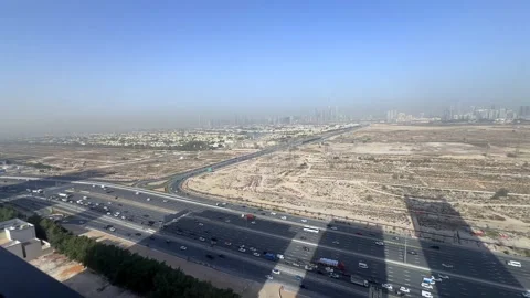 Vehicles move through Al Khail Road in Dubai, as the city skyline rises in the 動画素材 331414392