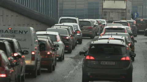 Vehicles Moving Slowly in a Traffic Jam Seen From Behind Stock Footage 100037637