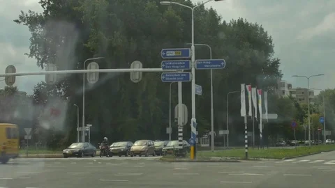 Vehicles moving on the street while traffic waiting for the signal on other side Stock Footage 73690102