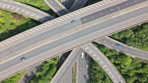 Vehicles Navigate Intricate Highway Interchange Above Green Trees Stock Footage 336953445