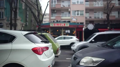 Vehicles pass in slow motion in front of alcohol places in Kızılay, Ankara. Stock Footage 180248681