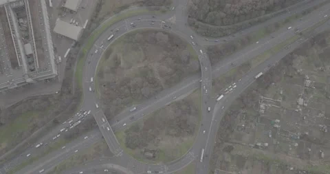Vehicles passing large roundabout above multilane trunk road Stock Footage 170905144