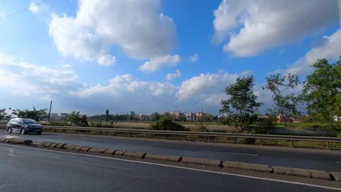 Vehicles passing through beautiful road in India Stock Footage 124190963