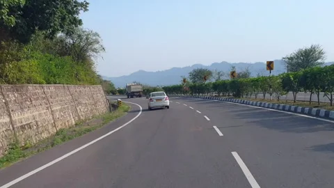 Vehicles passing through a road Stock Footage 264845363