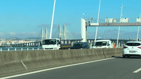 Vehicles passing on Vasco da Gama Bridge in bright daylight Stock Footage 320712126