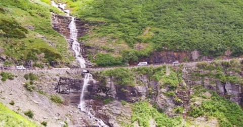 Vehicles passing a waterall Stock Footage 44234464