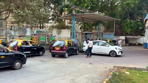 Vehicles Queue up for Compressed Natural Gas CNG at Refueling Station in Mumb Stock Footage 329614882