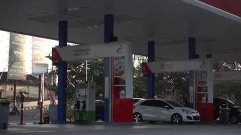 Vehicles queue at the Pertamina gas station Stock Footage 295870315