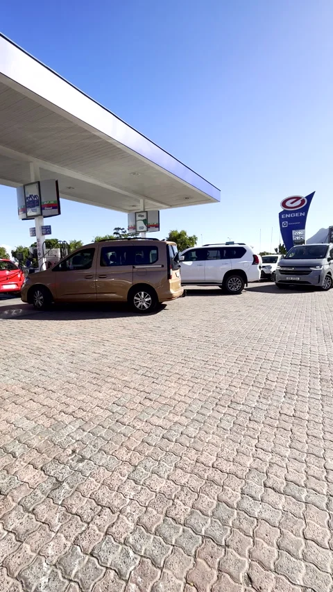 Vehicles queueing to fill up with fuel at Engen petrol station before price Stock Footage 341546251