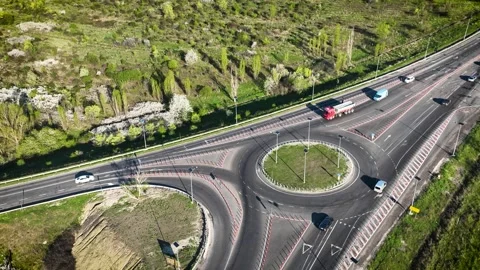 Vehicles on a roundabout junction. Roundabout with barriers. Stock Footage 273711867