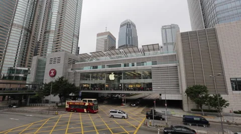 Vehicles run past an Apple store at IFC  in Hong Kong Central Stock Footage 45135388