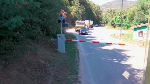 Vehicles standing at ramp while train is passing by in Mokra Gora. Видео 162672136
