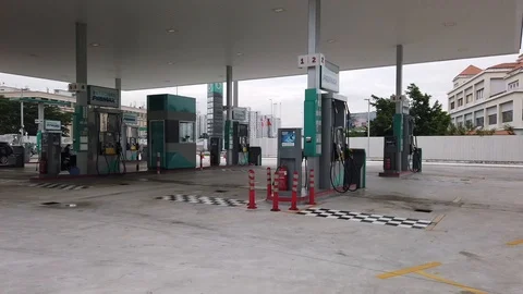 Vehicles stopped at Petronas's Petrol station in the city to fill gasoline. Stock Footage 107174953
