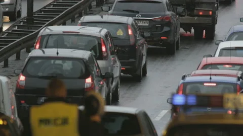 Vehicles Stuck in a Traffic Jam. Policeman Putting on a Hat Stock Footage 88155586