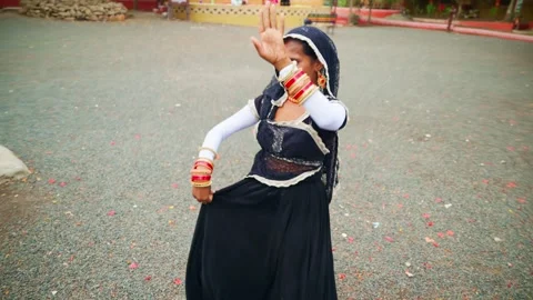 Veiled dancer spins elegantly beside cultural gathering Stock Footage 312729405